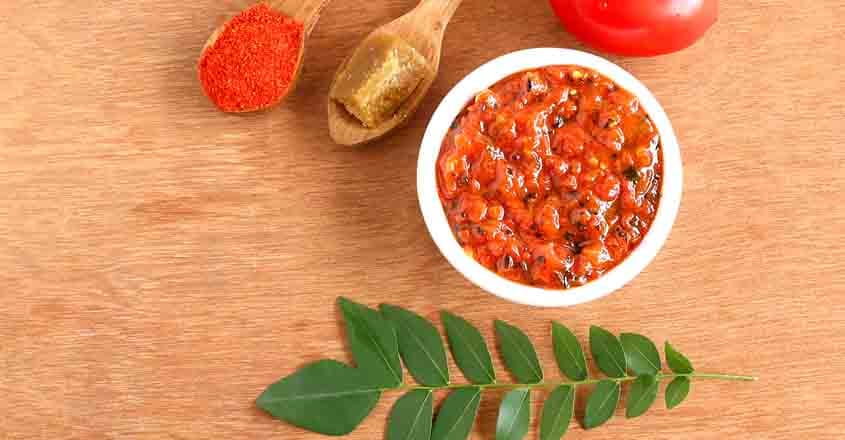 582281230 Indian food tomato chutney, a vegetarian, healthy, traditional and popular side dish for items like idli, dosa and chapati.