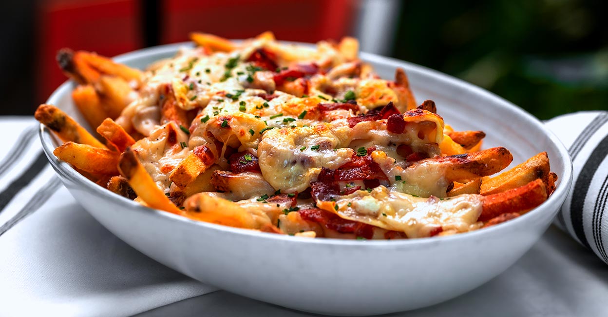 nachos-pic All you need are some diced veggies, mayo and seasoning to spice up this nachos snack plate. Photo: Shutterstock/Nikita M production
