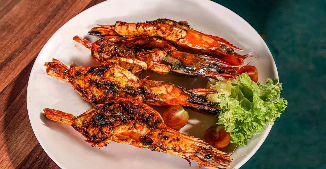 Butterflied prawns are the prawns cut in half, to flatten them out to grill easily. Photo: Jimmy Kamballur
