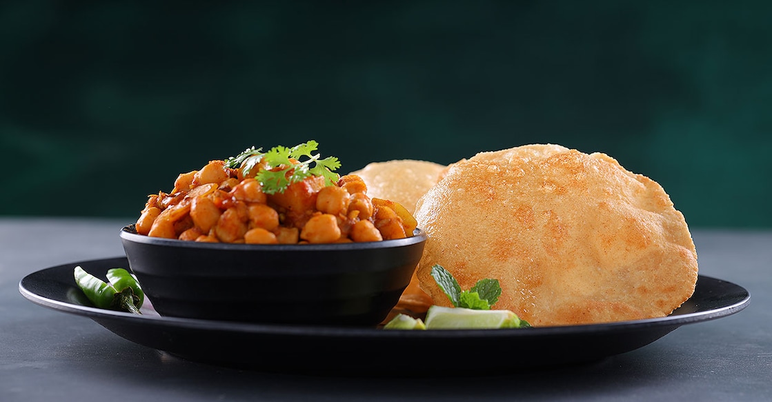 Pooris with chickpea curry. Photo: Shutterstock/AALA IMAGES
