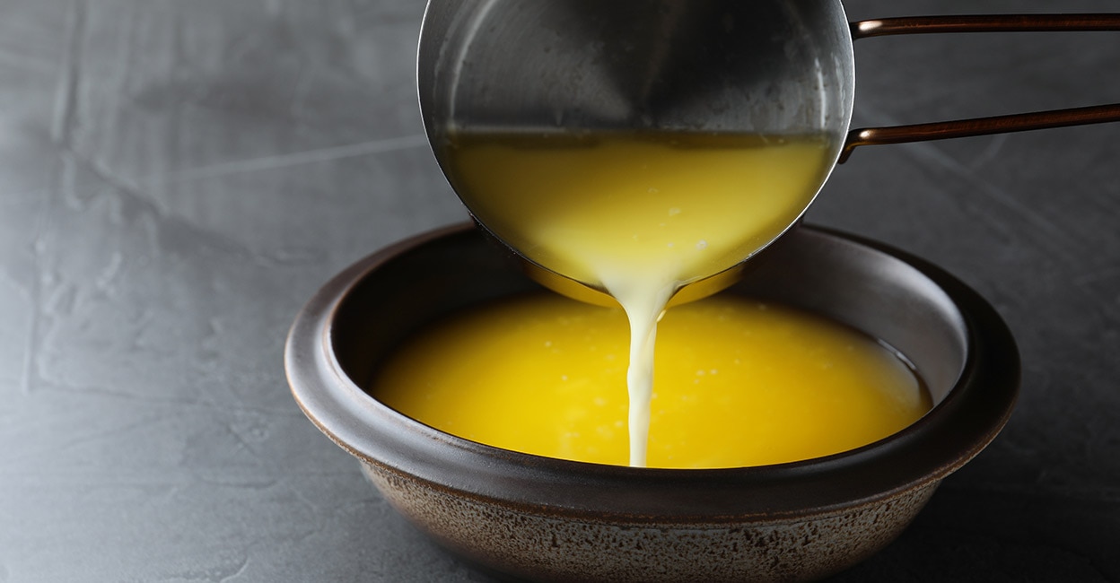 Ghee Pouring clarified butter into a bowl. Photo: Shutterstock/New Africa