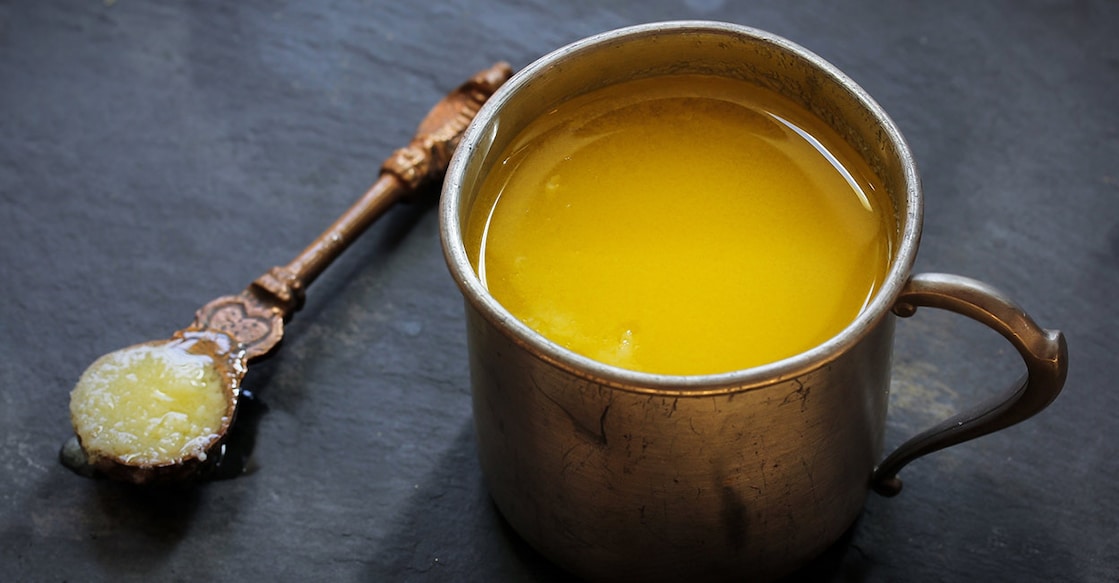 Ghee Ghee or clarified butter in a rustic cup. Photo: Shutterstock/vm2002