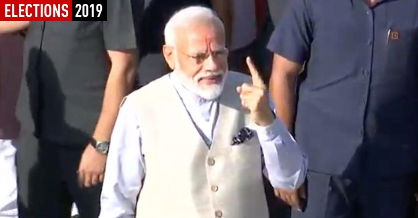 Ahmedabad: Prime Minister Narendra Modi shows his inked finger after casting his vote in Ahmedabad, Gujarat on April 23, 2019. (Photo: PIB/IANS)