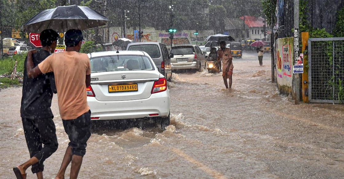 Commuters wade through a waterlogged road amid rains, in Thiruvananthapuram, Wednesday, May 29, 2024. Photo: PTI. 