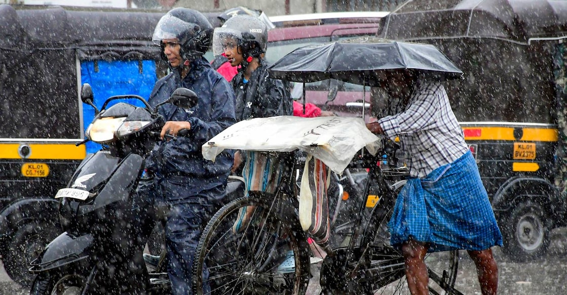 Commuters move on a road during rain, in Thiruvananthapuram, Wednesday, May 29, 2024. Photo: PTI.