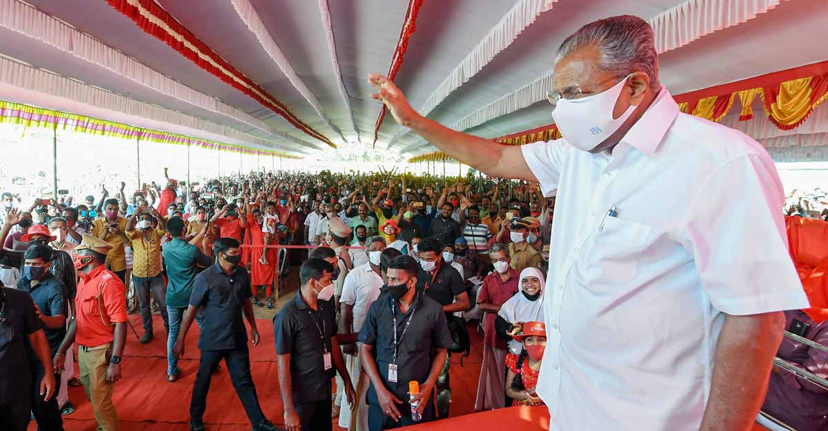 Kerala CM Pinarayi Vijayan greets party supporters during an election campaign ahead of Kerala Assembly Polls, in Thiruvananthapuram, March 26, 2021. PTI