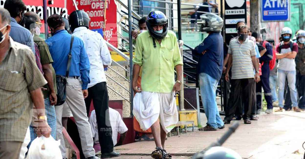 People queue up outside a Bevco outlet in Thiruvananthapuram. 