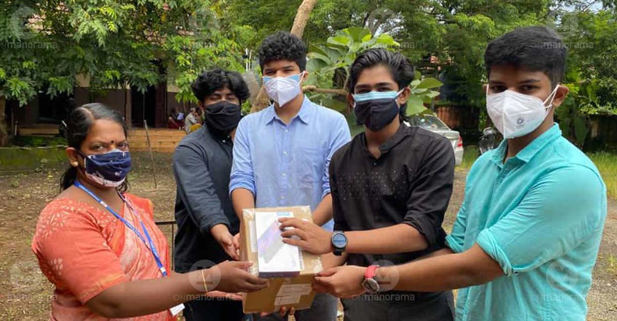 Students of Pallikoodam School handover Tablets to a teacher at government school in Kumarakom Students of Pallikoodam School handover Tablets to a teacher at government school in Kumarakom