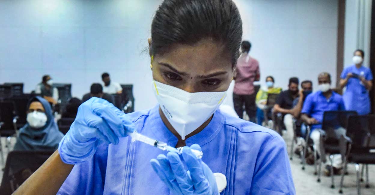 A health worker prepares a dose of the COVID-19 vaccine Sputnik V to administer to a beneficiary, at a hospital in Kochi, Tuesday, July 13, 2021.  Photo: PTI