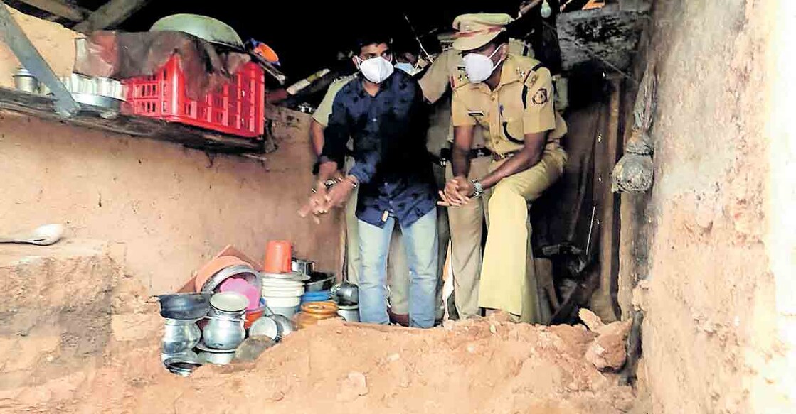 Accused Binoy with the police during evidence collection at his house.