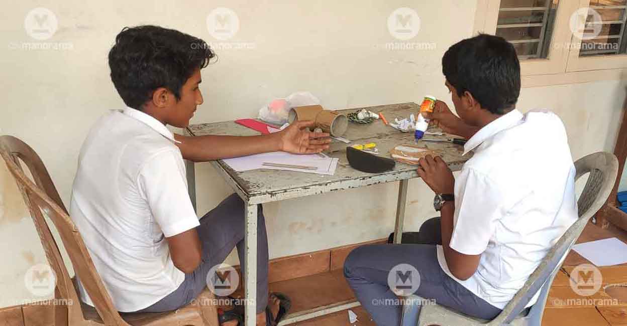 Class IX students Aflah K S and Shahid K C making a prototype rocket sitting in the corridor. Panchayat librarian Binoy Mathew said libraries can have a 'makers' room' for children to try out what they read. Photo: George Poikayil | Manorama. Class IX students Aflah K S and Shahid K C making a prototype rocket sitting in the corridor. Panchayat librarian Binoy Mathew said libraries can have a 'makers' room' for children to try out what they read. Photo: George Poikayil | Manorama.