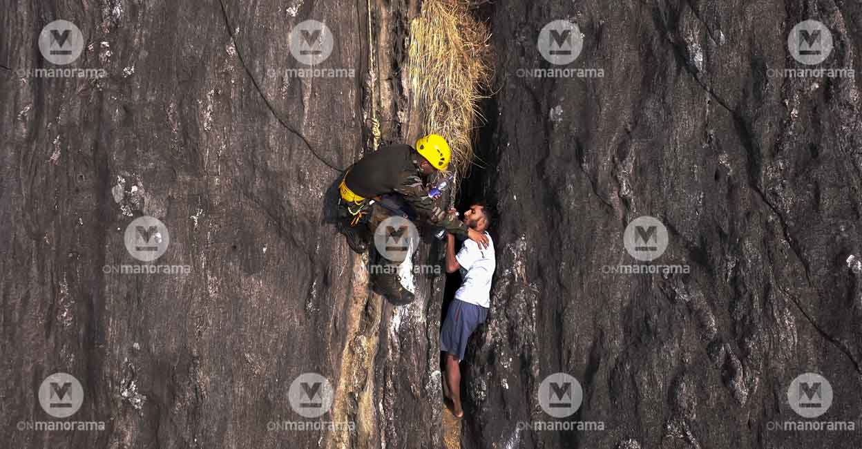 babu-rescue-sooraj-1 Babu, given water by the Indian Army personnel. Photo: Manorama/Sooraj P Nath
