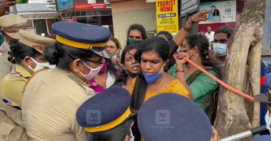 Policewomen stop protesting transgender persons near the Aluva Police Station on Thursday. 