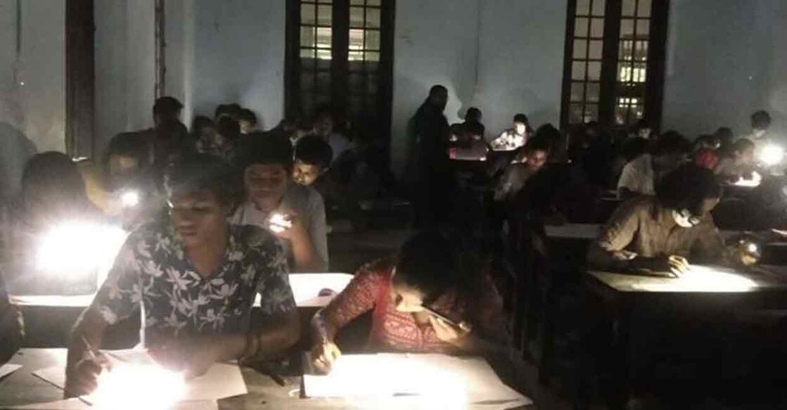 Students use their mobile phone flashlights to write an exam at the Maharaja's College in Ernakulam. 

