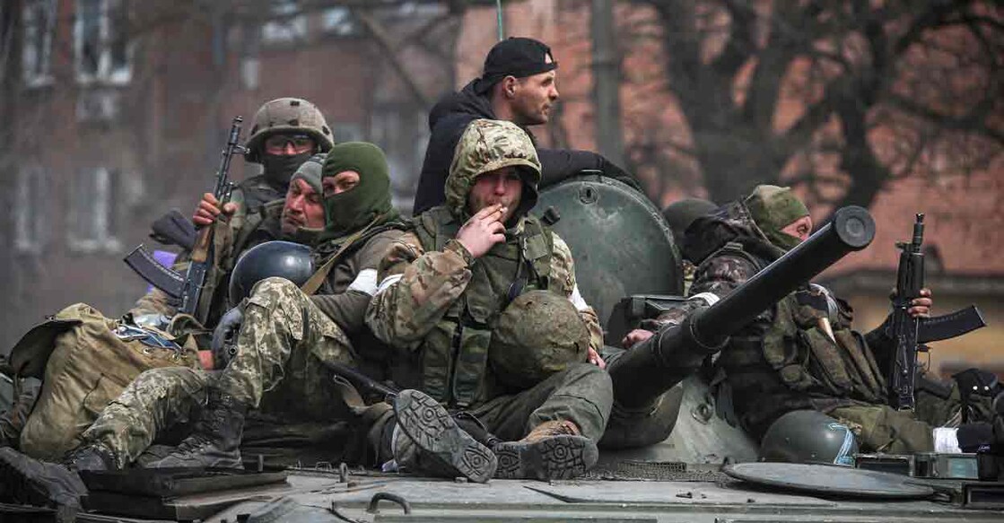 Service members of pro-Russian troops are seen atop of an armoured vehicle during Ukraine-Russia conflict in the southern port city of Mariupol, Ukraine April 21, 2022. REUTERS/Chingis Kondarov