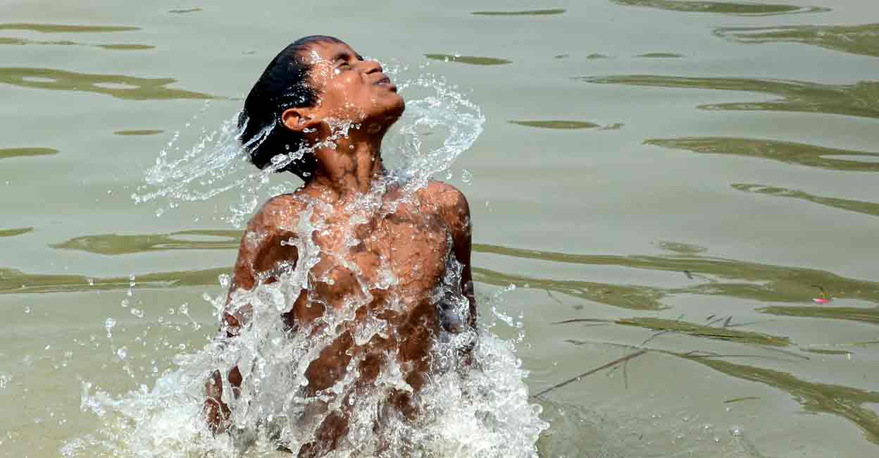 PTI04_28_2022_000107A A boy takes a dip in a canal on a hot summer day, on the outskirts of Amritsar, Thursday, April 28, 2022. (PTI Photo)