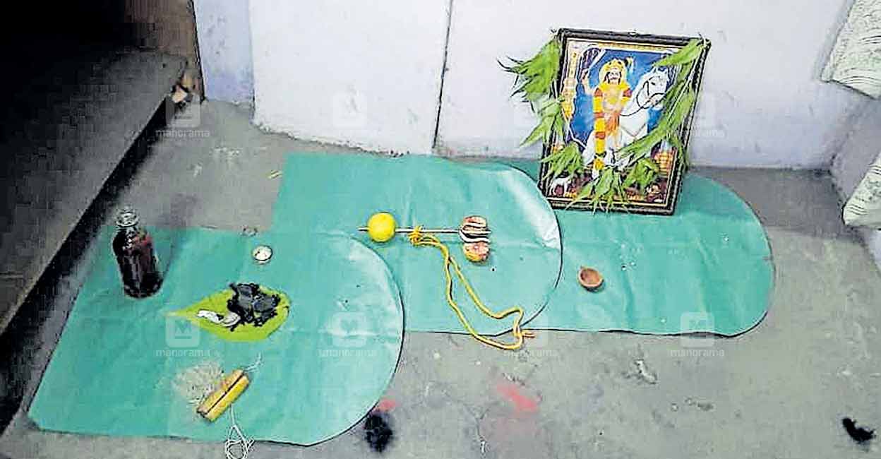 A tiny spear with a lime impaled on it, a bottle of liquor, betel leaves, and a framed photograph of a Tamil deity, which were used by the burglars to conduct the 'puja' at the finance firm. PHOTO: Manorama