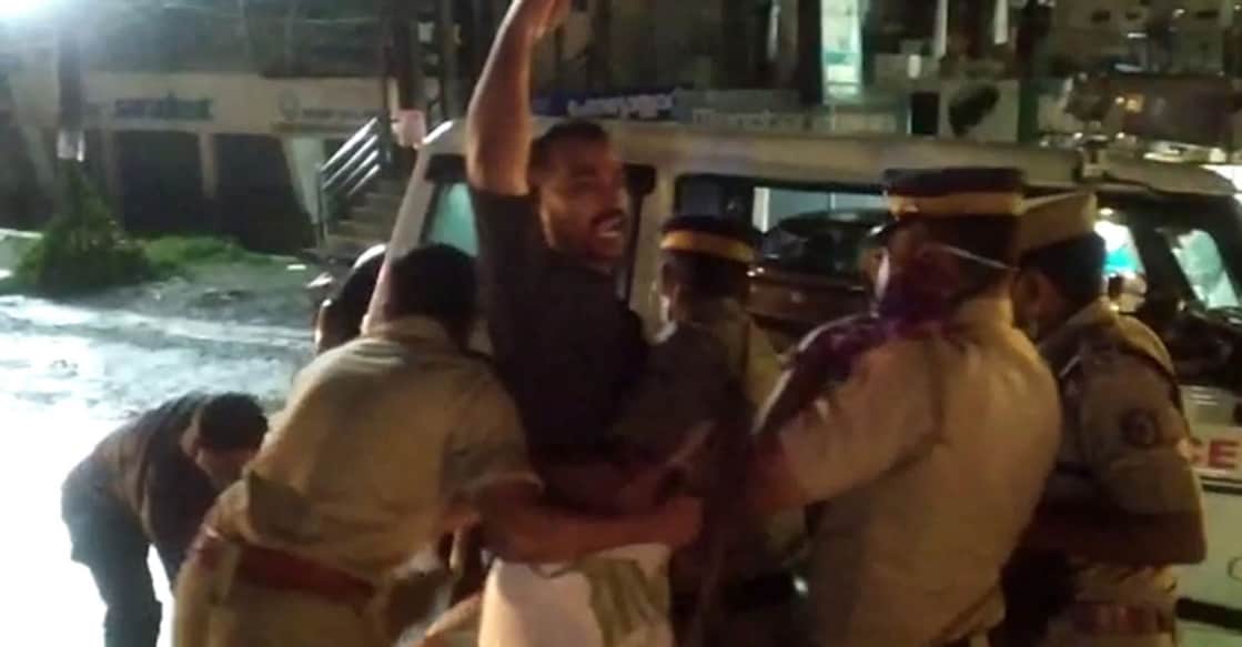 black flag protest A protester being removed by the police at Vadakara.