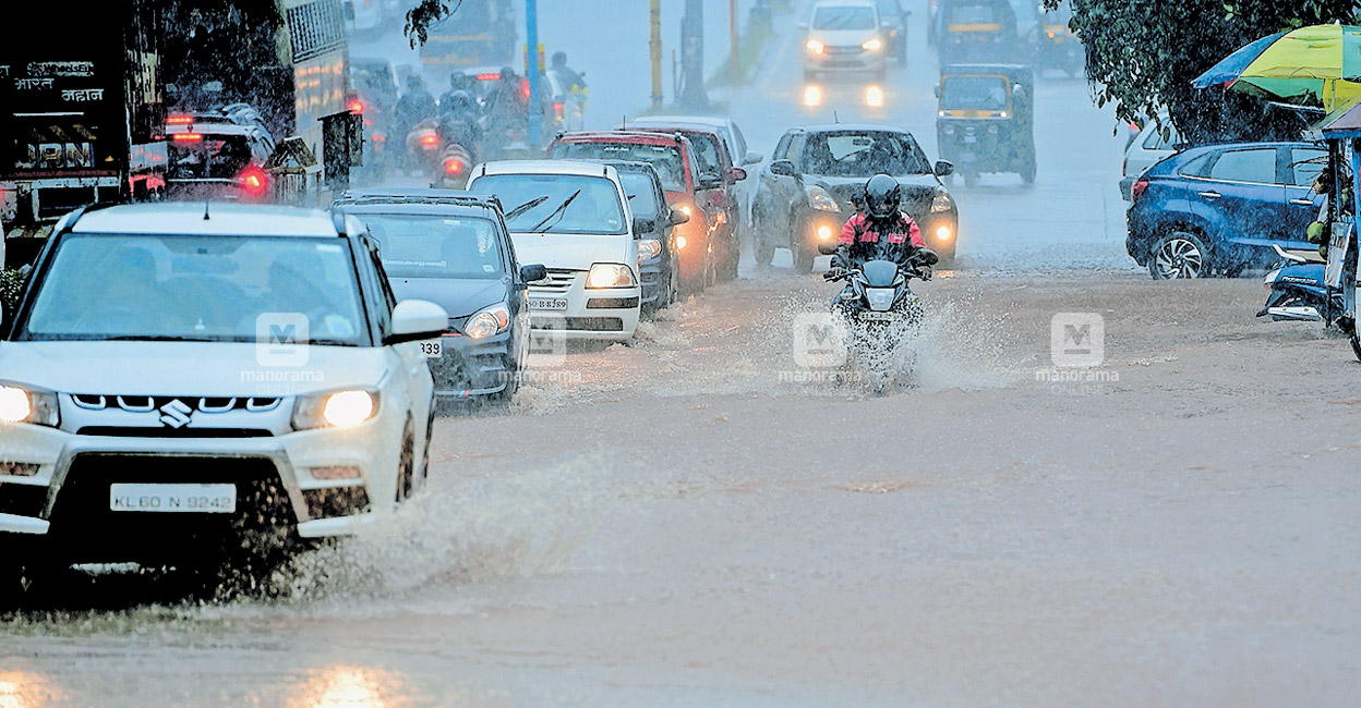 Vehicles passing through an inundated MG Road in Kasaragod following incessant rain. PHOTO: Manorama