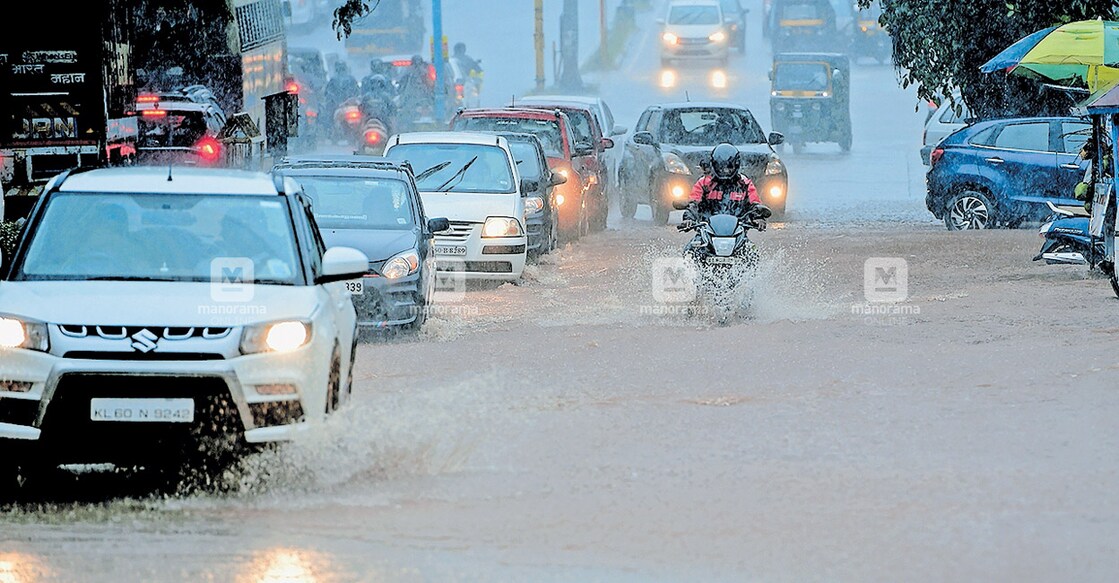 Vehicles passing through an inundated MG Road in Kasaragod following incessant rain. PHOTO: Manorama