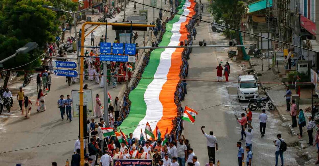 PTI08_08_2022_000170A Ahmedabad: Students carry a giant Indian national flag as they participate in a Triranga Yatra oraganised as part of Azadi ka Amrit Mahotsav celebrations, in Ahmedabad, Monday, Aug. 8, 2022. Photo: PTI