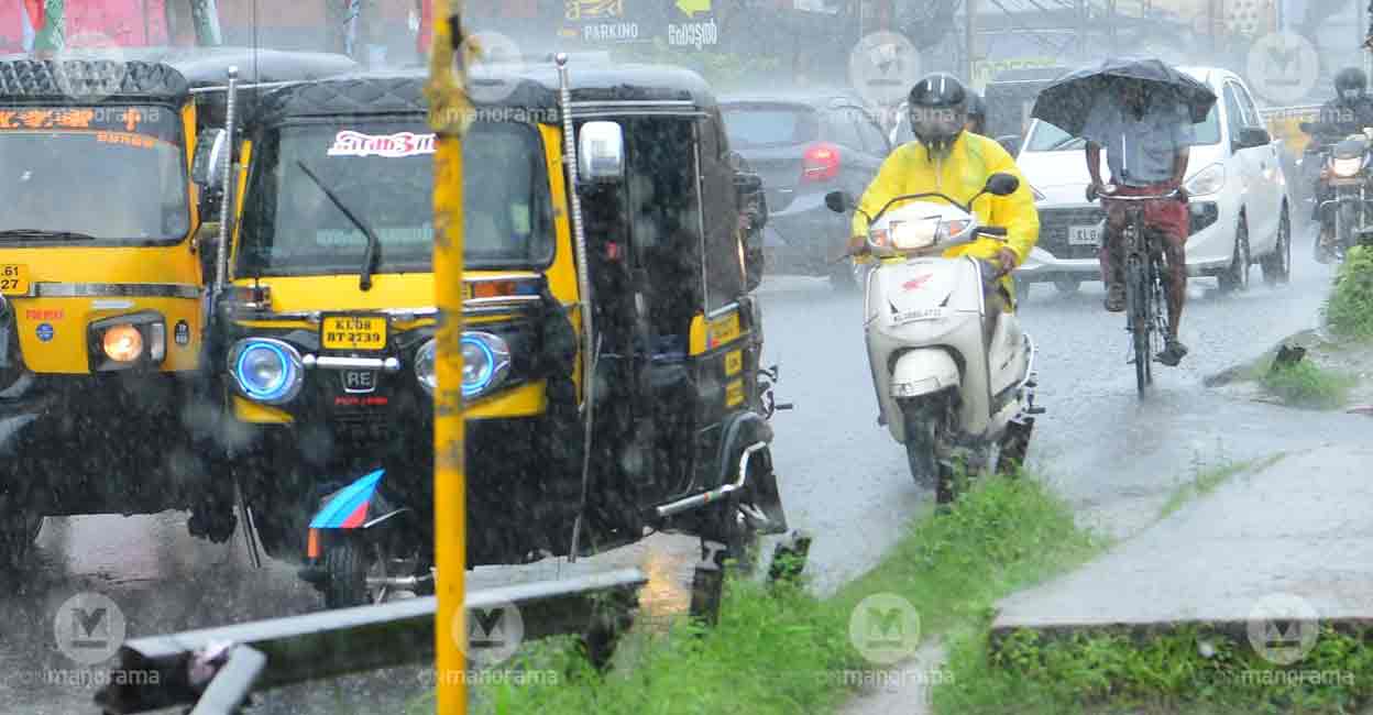 Vehicles ply on a road in Thrissur amid heavy rains. Photo: Russel Shahul/Manorama