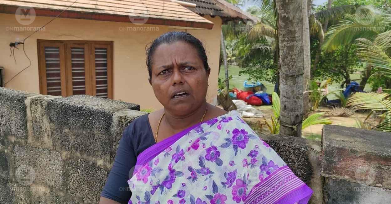 Annamma in front of her house at Poothura. The Muthalapozhi lake flows through the back of her house. Photo: Ayyappan R/Manorama Annamma in front of her house at Poothura. The Muthalapozhi lake flows through the back of her house. Photo: Ayyappan R/Manorama