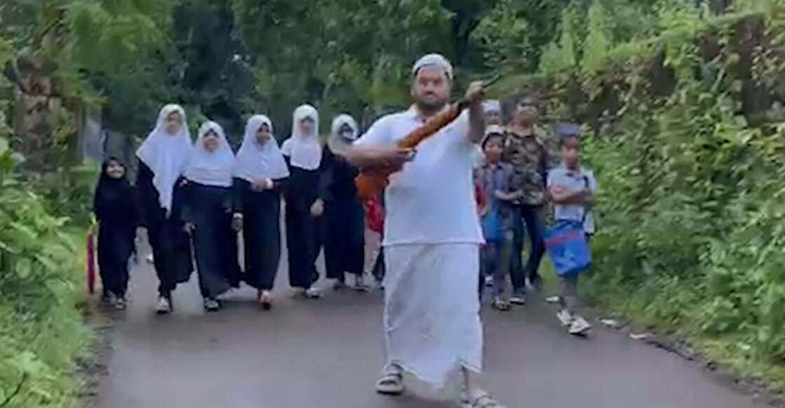 Sameer escorts his daughter and other children in the neighbourhood making their way to madrasa with an air gun to ensure their safety against stray dog attacks. Photo: Manorama