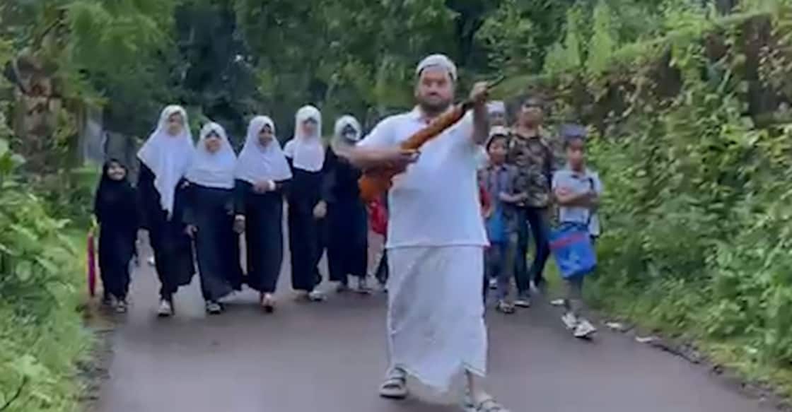 father-with-gun-kasargod-stray-dog Sameer escorts his daughter and other children in the neighbourhood making their way to madrasa with an air gun to ensure their safety against stray dog attacks. Photo: Manorama