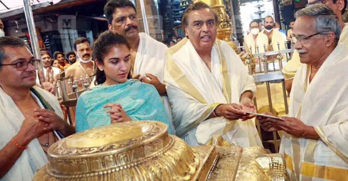 Mukesh Ambani at Guruvayur. His son's fiancee Radhika Merchant looks on.