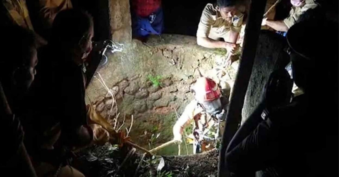 Fire and Rescue officials bring the body out of the well. Photo: Manorama Online. 