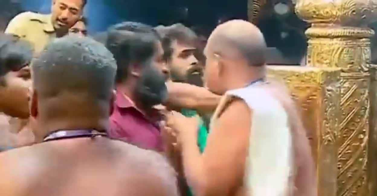 sabarimala-manhandling Screengrab from a video shared by K Surendran shows devaswom workers' union leader, Arunkumar allegedly manhandling Ayyappa devotees.