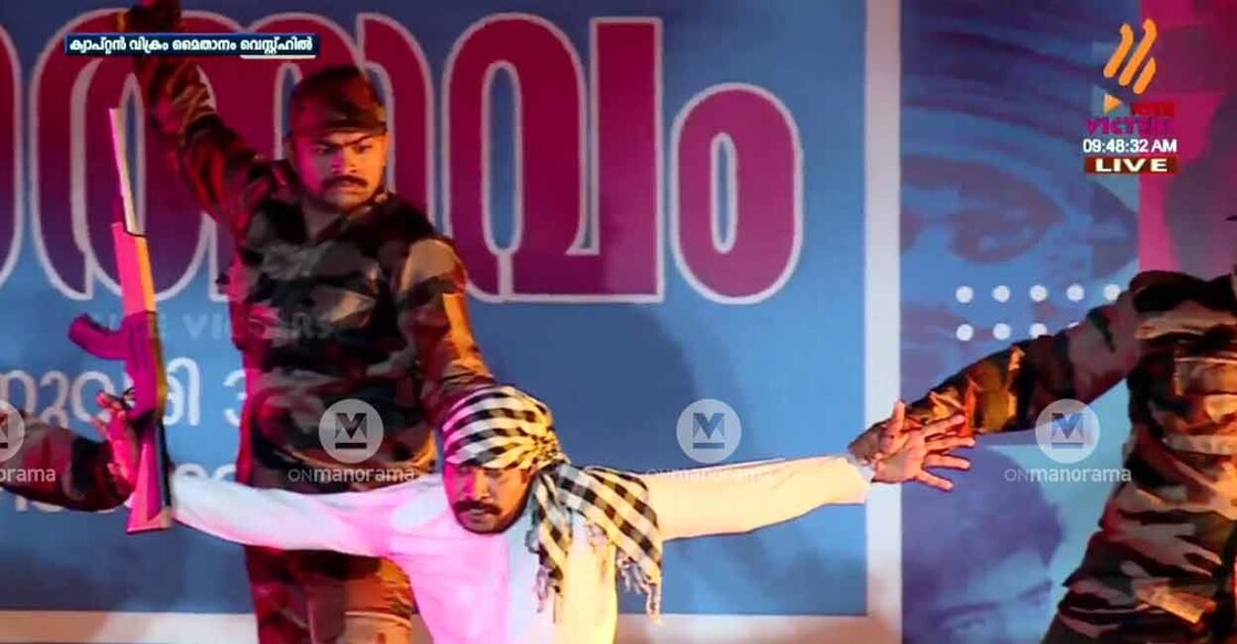 A man who plays the terrorist, is sporting a Keffiyeh, an Arab scarf, as he is apprehended by the Indian army during the musical staged on the inaugural venue of the 61st Kerala School Kalolsavam at West Hill in Kozhikode on Tuesday. Photo: Screenshot/Victers
