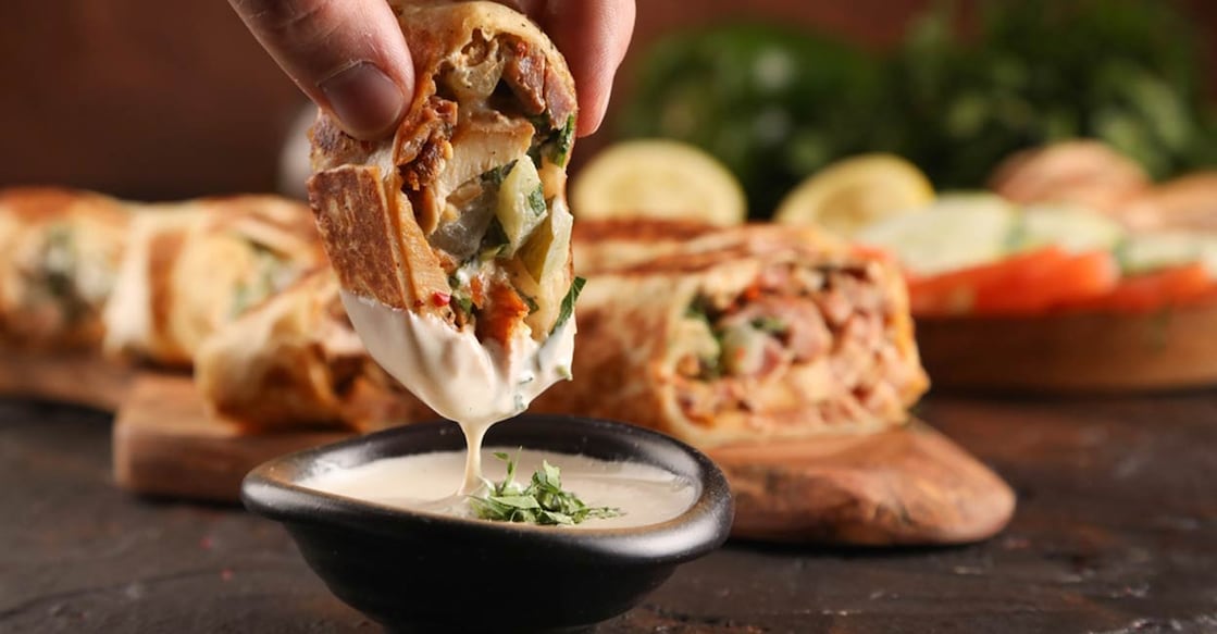 Shawarma is a popular Middle-Eastern dish consisting of meat cut into thin slices, stacked in a cone-like shape, and roasted on a slowly-turning vertical rotisserie or spit. Photo: Shutterstock