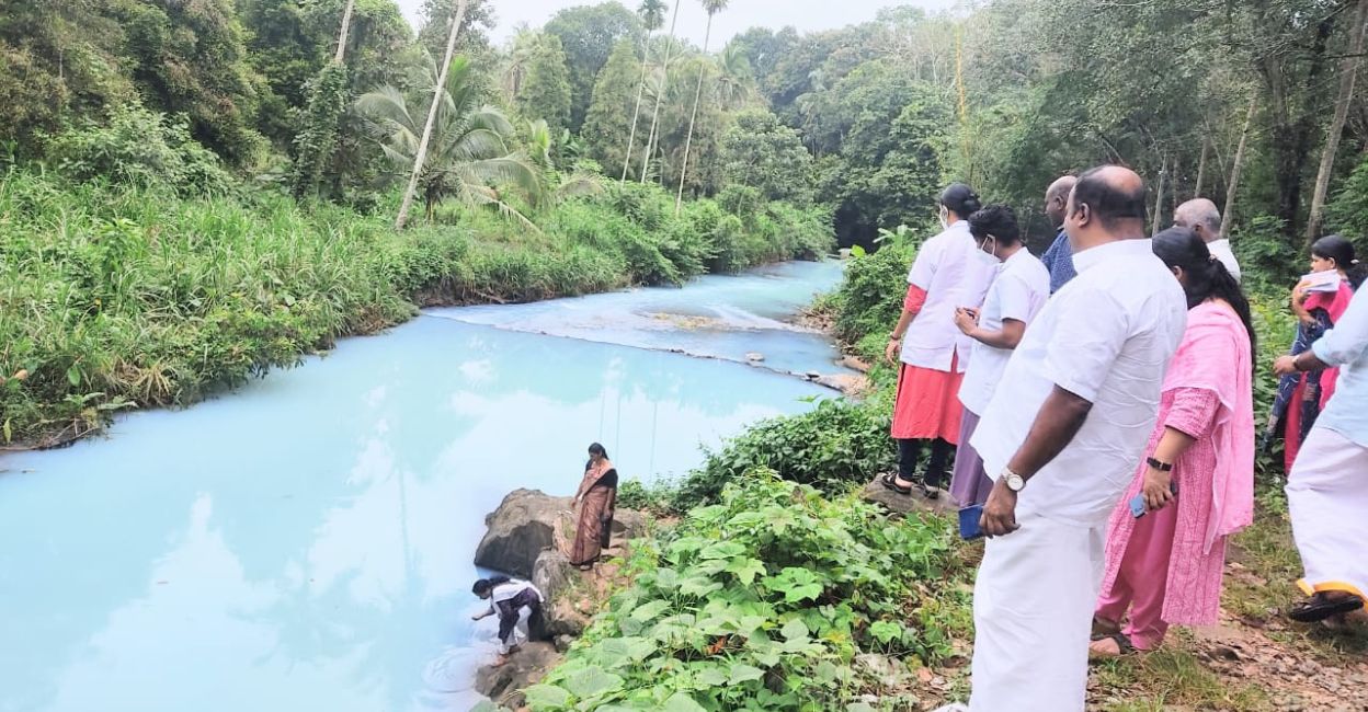 Officials collect samples from from a contaminated stream connected to the Meenachil River in Kottayam. Photo: Special arrangement