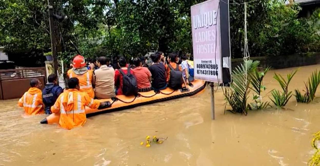Fire Force personnel evacuates stranded people from flood-hit  area of Thiruvananthapuram. Photo: Manorama News