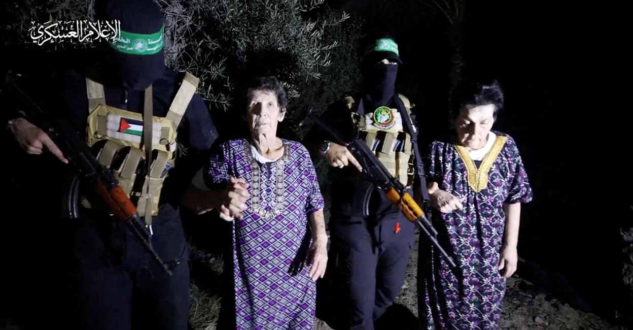 Yocheved Lifshitz and Nurit Cooper (also known as Nurit Yitzhak) who were held hostages by Palestinian Hamas militants, are released by the militants, in this video screengrab obtained by Reuters on October 23, 2023. Photo: Al-Qassam Brigades, military wing of Hamas/Handout via REUTERS