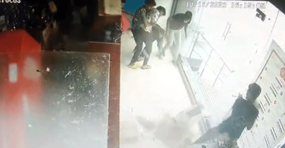 A screengrab from a CCTV footage showing consumers taking refuge as cartons of beer bottles are dragged down by the wind, at the BEVCO outlet near Infopark in Kakkanad on Friday. Photo: Special arrangement