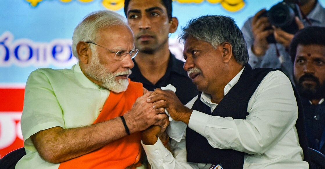 PTI11_11_2023_000380B Narendra Modi consoles Madiga Reservation Porata Samithi chief Manda Krishna Madiga who got emotional during a public meeting in Secunderabad, Telangana. Photo: PTI