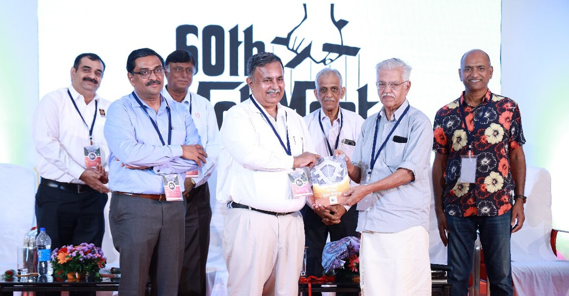 Dr Vinod V Thomas hands over the first copy of Manipal Golden Memories to K C Eapen at the 50th alumni meet in Kottayam. (From left) Prof Vinod Kamath, Alex Zachariah, Prof M V Kini, Prof K Kamalaksha and Shajan Mathew John are also seen. Photo: Special arrangement.
