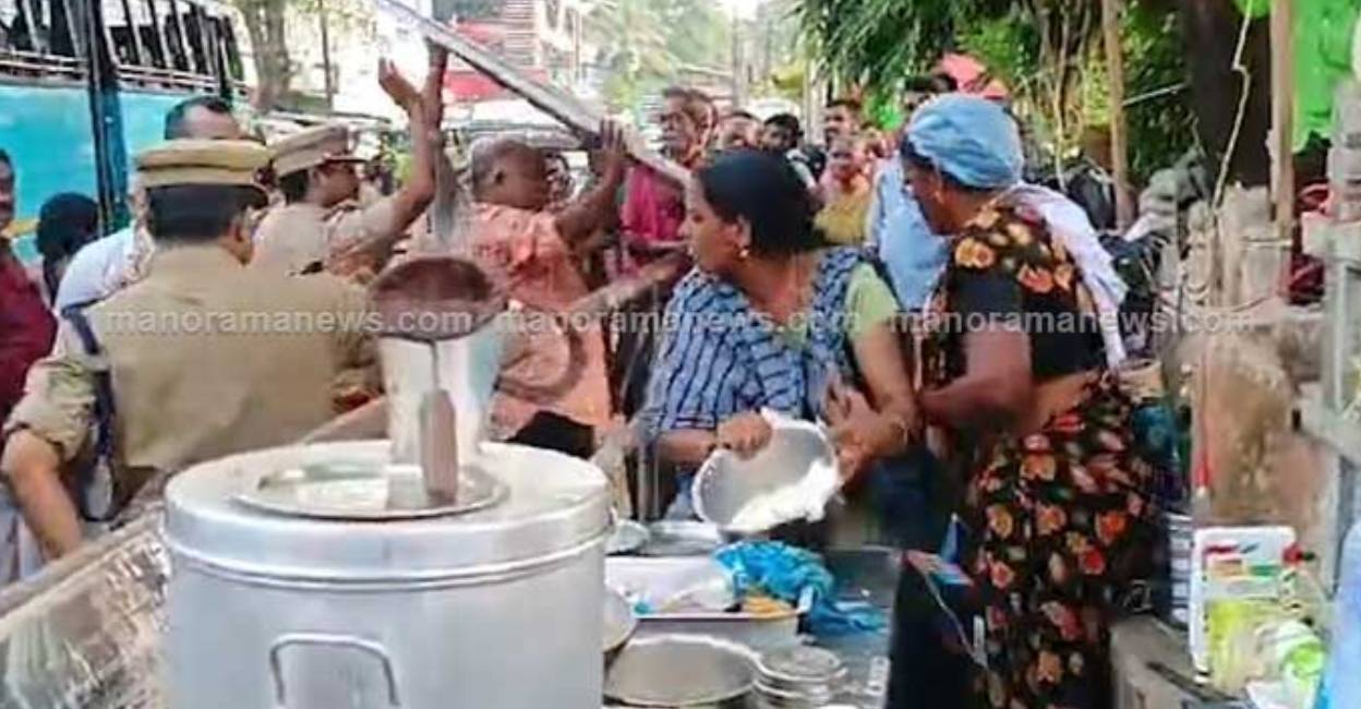 Alappuzha woman pours hot milk on officials as eviction drive to clear footpath ends up in high drama . Photo: Manorama News
