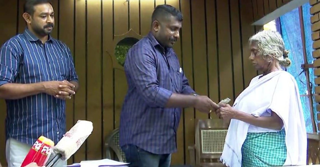 Bank officials hand over pension amount to Mariyakutty. Photo: Manorama