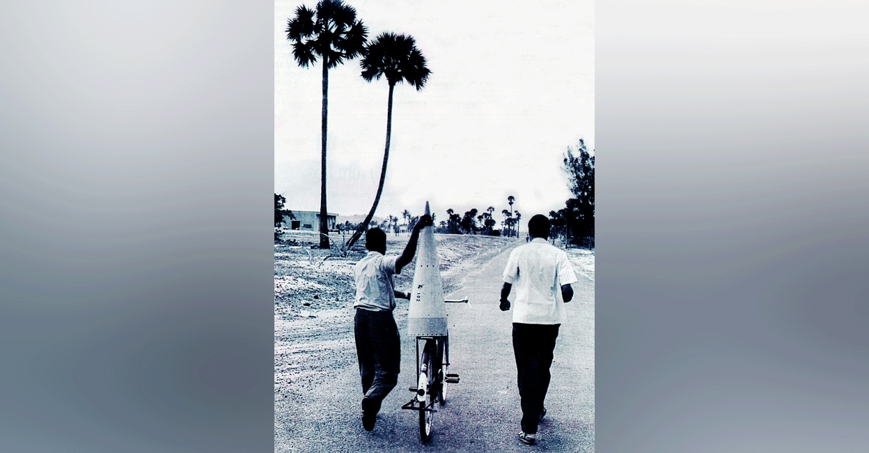 thumba-rocket-on-cycle In this file photo from 1963, the nose cone of the Nike-Apache rocket is taken on a bicycle to the launch site in Thumba, Thiruvananthapuram. Photo: Henri Cartier-Bresson