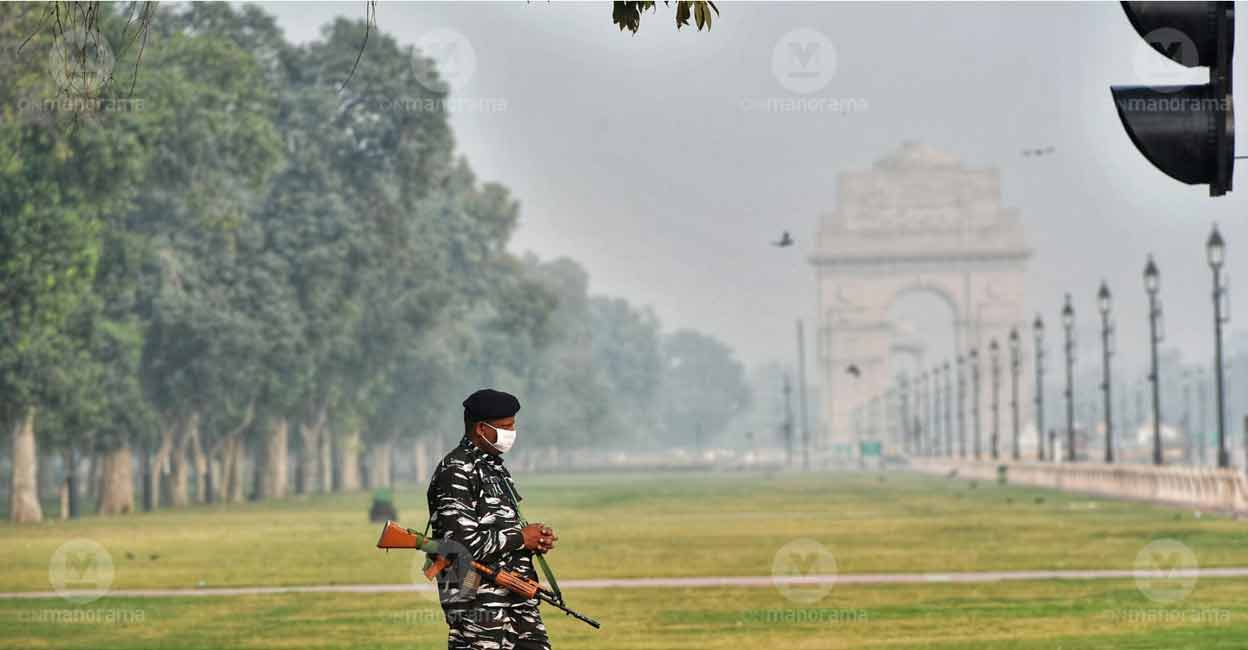 Delhi pollution A security personnel walks in front of the India Gate as a thick smog envelops Delhi. Photo: Josekutty Panackal/Manorama