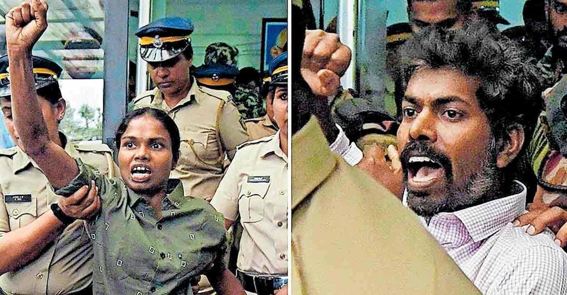 Maoists Unnimaya and Chandru raise slogans as they were taken into custody. Photo: Manorama