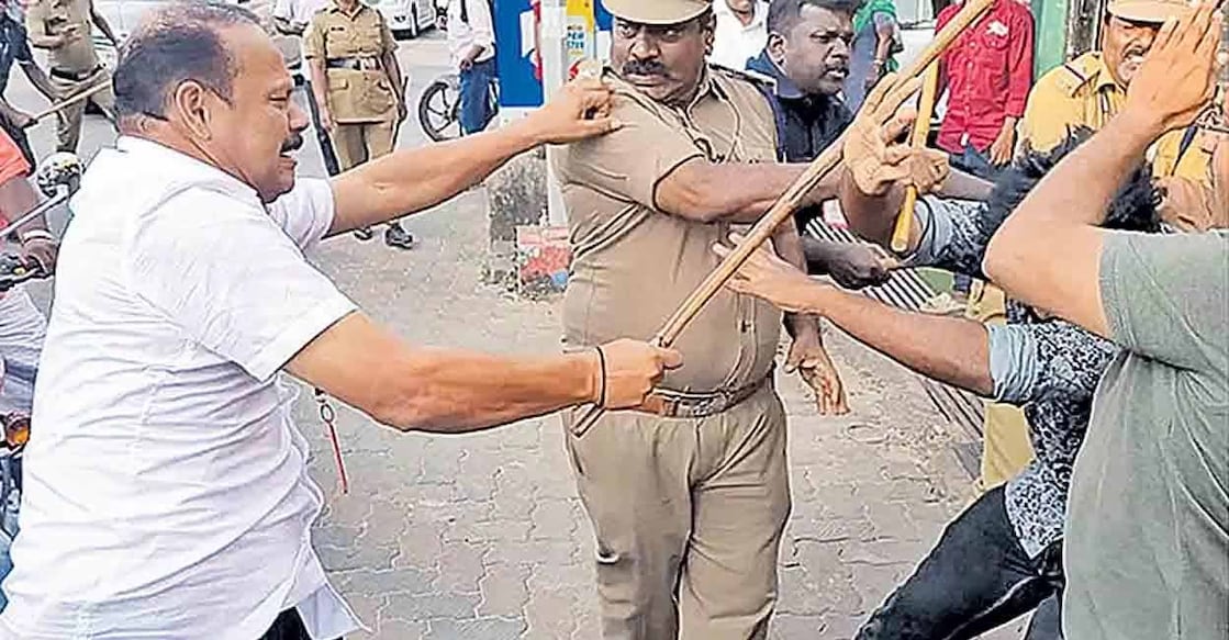 Gunman and escort policemen thrash protesters in Alappuzha. Photo: Manorama
