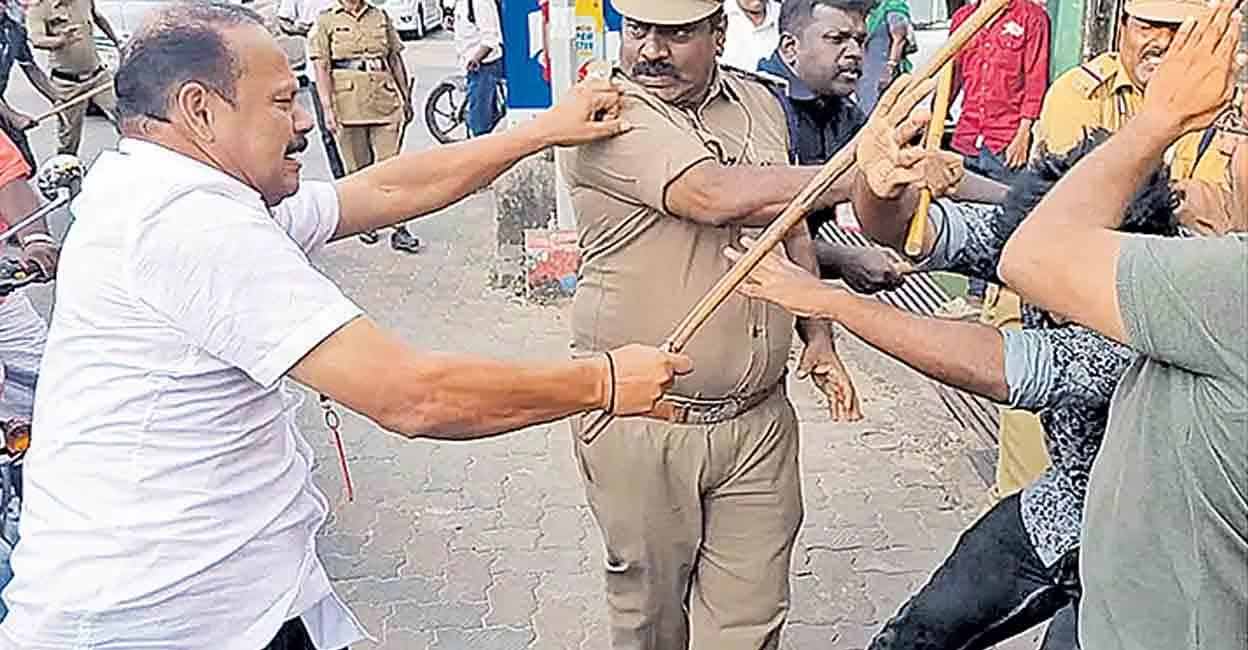 Gunman and escort policemen thrash protesters in Alappuzha. Photo: Manorama