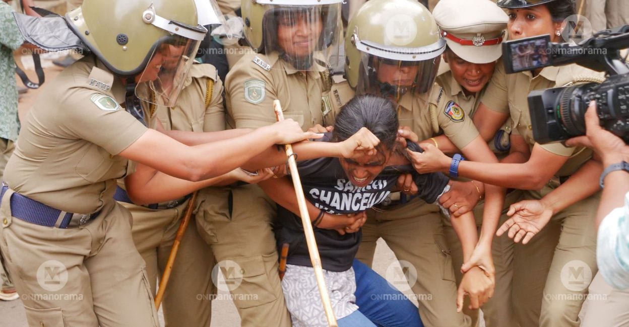 sfi-protest-calicut-governor-1 Police personnel drag away a woman SFI activist as she raises slogans against the Governor at Calicut University. Photo: Nebula MP