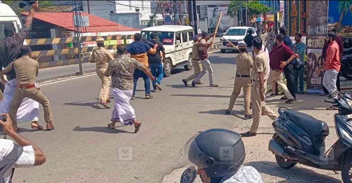 Youth Congress protesters being removed from the road by police after waving black flags at the bus in which the chief minister and his cabinet colleagues are travelling as part of the Nava Kerala Sadas. Photo: Manorama