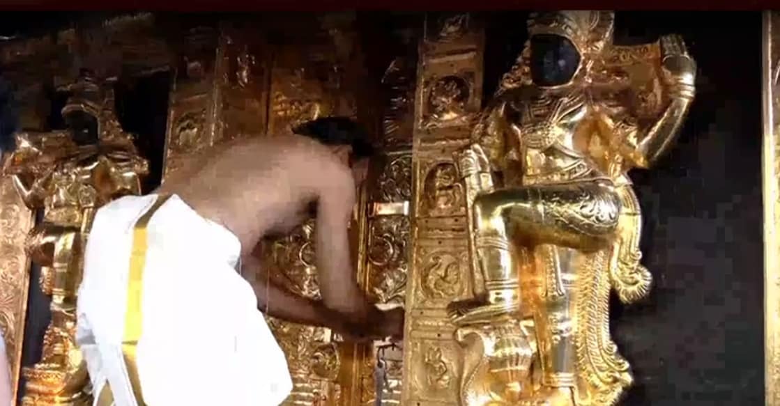 Mel Shanti P N Mahesh opens the doors to the sanctum sanctorum at Sabarimala. Photo: Screengrab/Manorama News